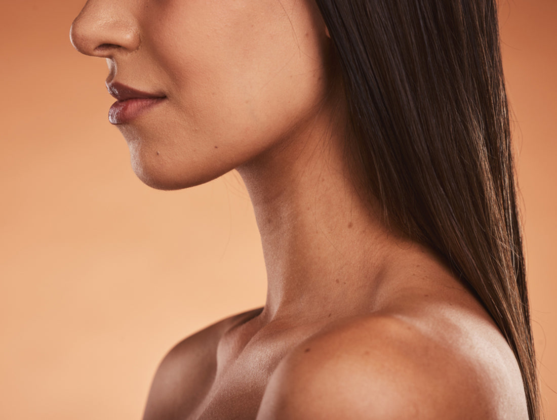 Closeup on the lower face and neck of a young woman with healthy skin. Photo credit: Jacob Wackerhausen / Getty Images