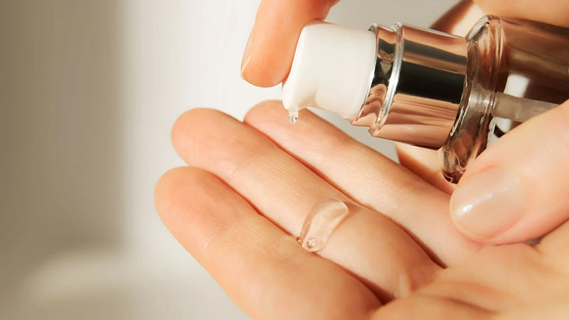 Closeup on a person pumping a drop of serum into their hand