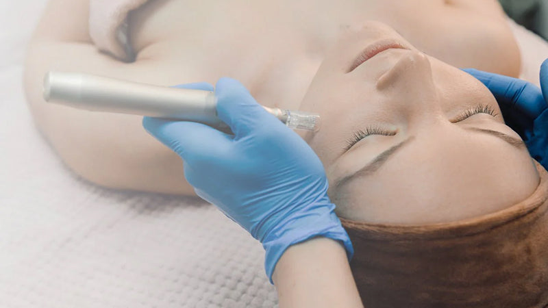 A young woman lies on a table receiving a cosmetic face procedure.