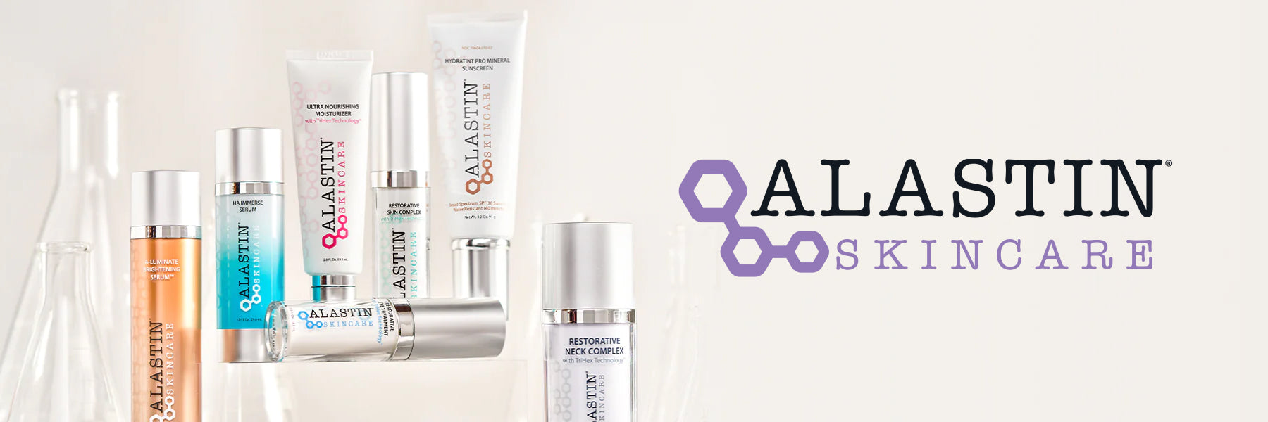 Alastin Skincare: Alastin products against a beige background with the Alastin Logo