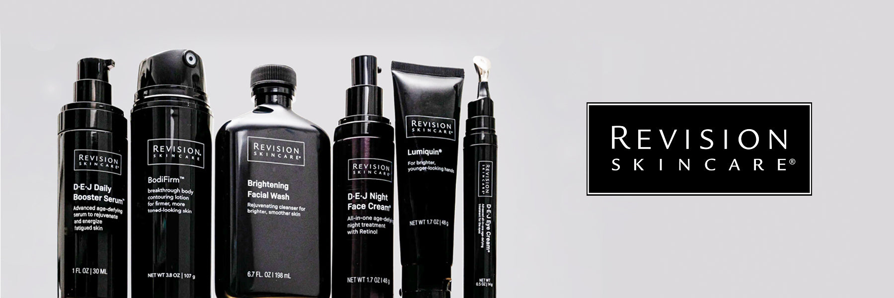 Six black Revision Skincare products stand against a pale grey background, with the Revision skincare logo to the right.