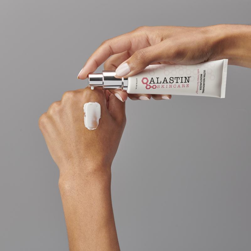 Model swatching cream moisturizer onto back of hand