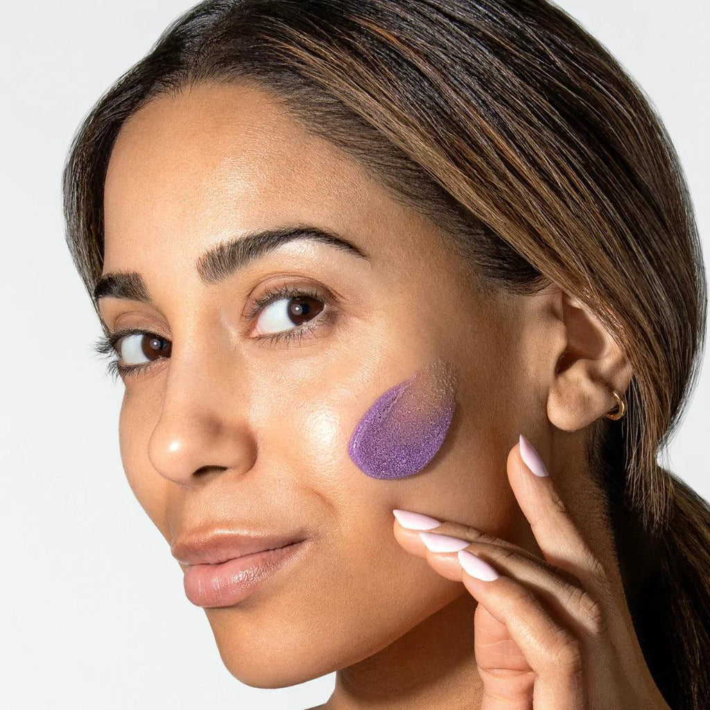 Alastin Skincare ReSURFACE Skin Polish Purple Scrub Swatch on Model's cheek