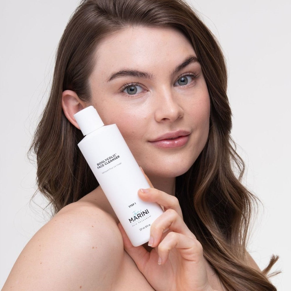 Model holding bottle of Jan Marini Bioglycolic Face Cleanser
